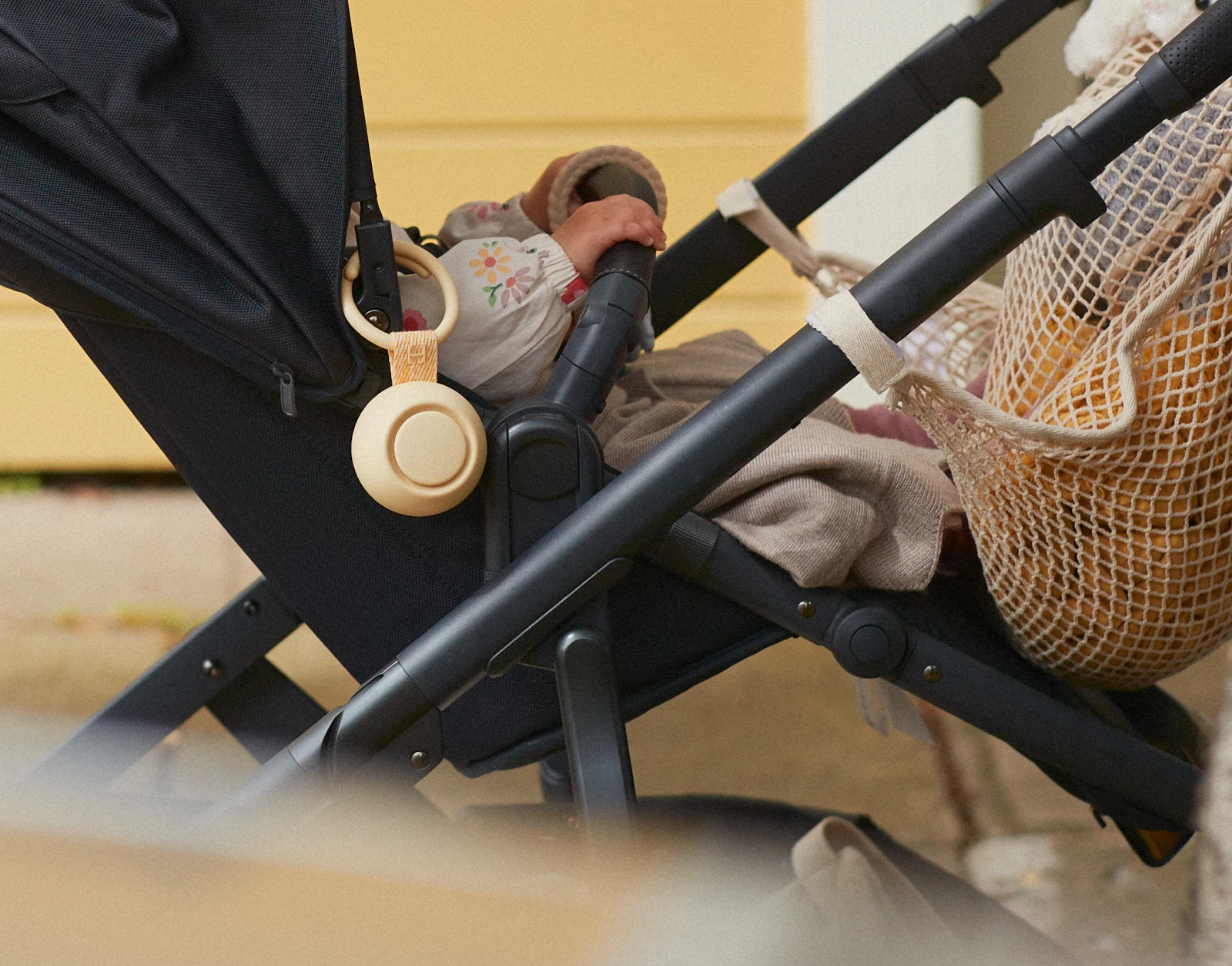 Hatch Go Honey clipped on a stroller with a baby in it