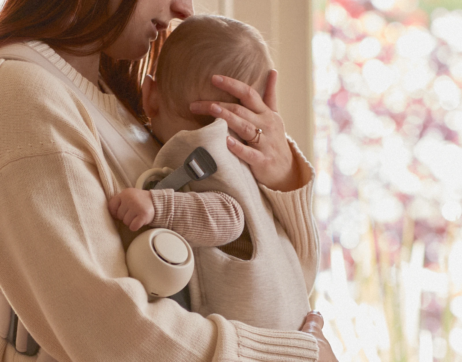 Hatch Go Putty clipped to a front baby carrier with a baby strapped in