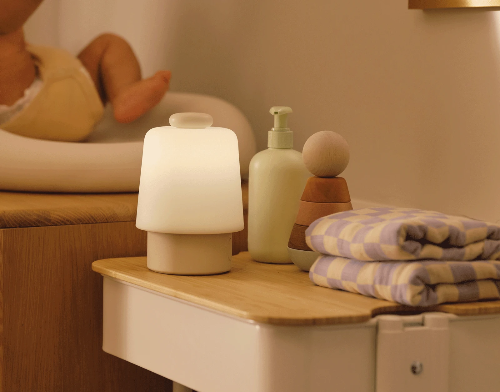 Hatch Baby Putty sitting on a nursery changing table