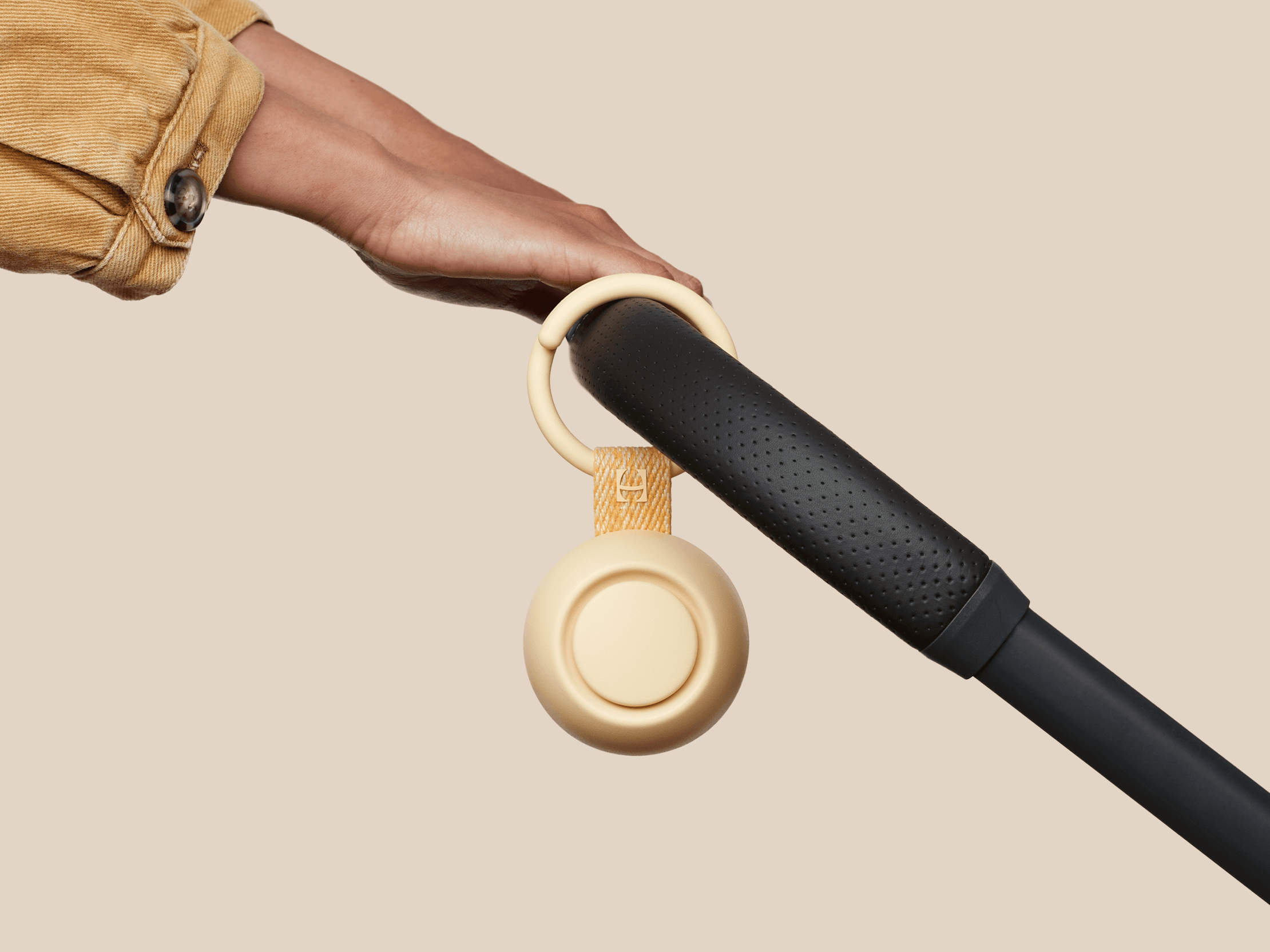 Hatch Go honey colorway clipped to baby stroller
