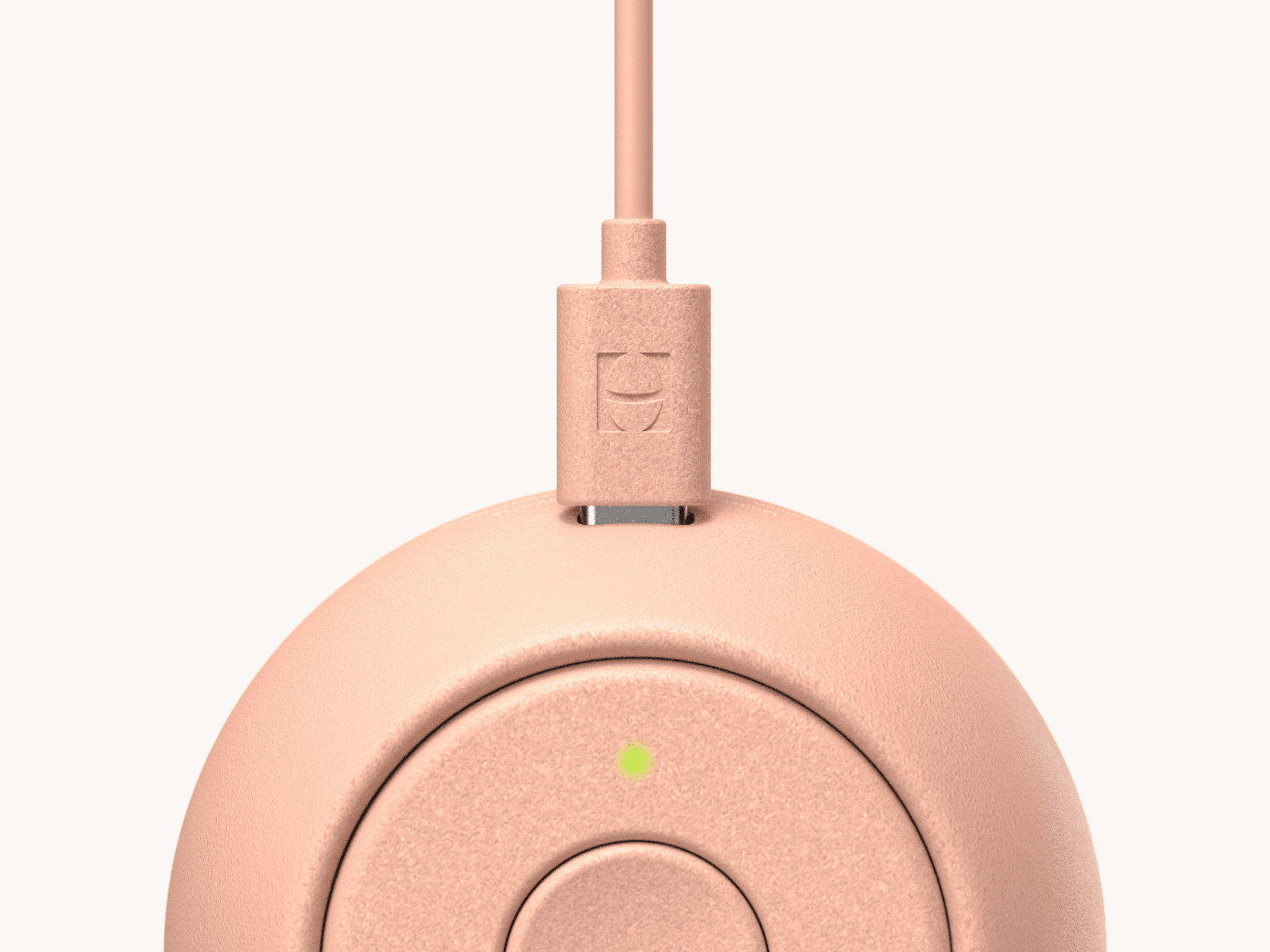 Hatch Go peach colorway with included charger plugged in