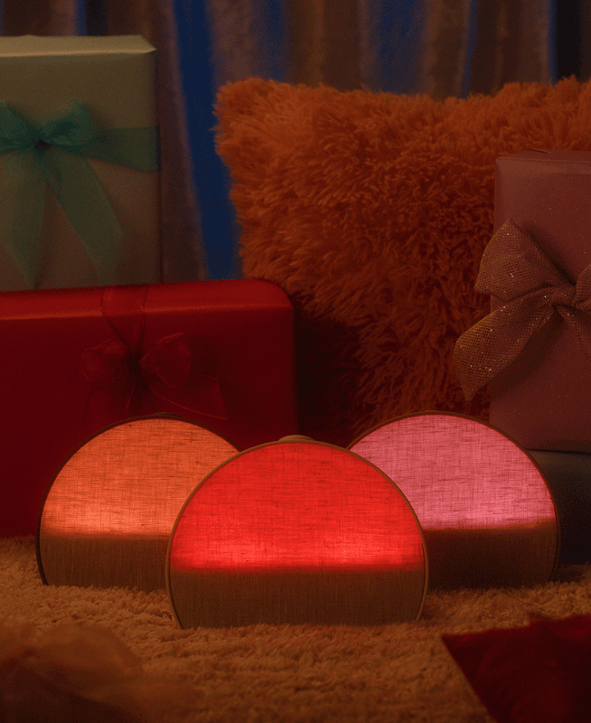 Hatch Restore 3 all 3 colorways sitting on a carpet next to holiday presents