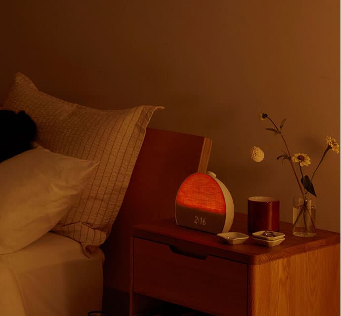 Person sleeping in bed with Hatch Restore red light